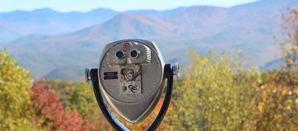 A binocular viewer peers over the colorful fall Smoky Mountain range, inviting visitors to look closely.